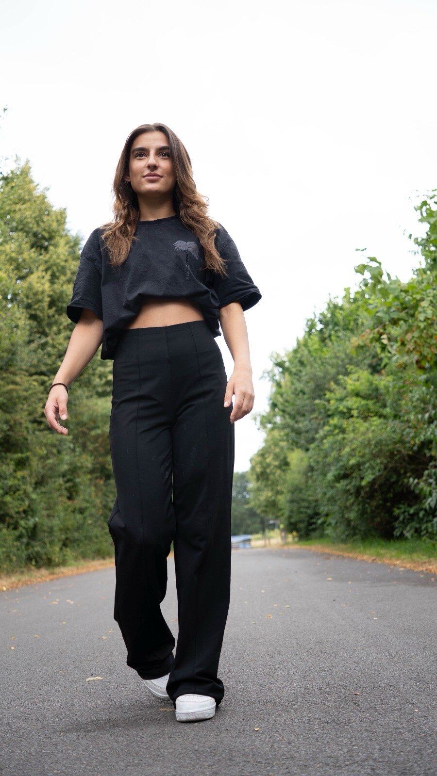 Walking portrait in black outfit, urban setting