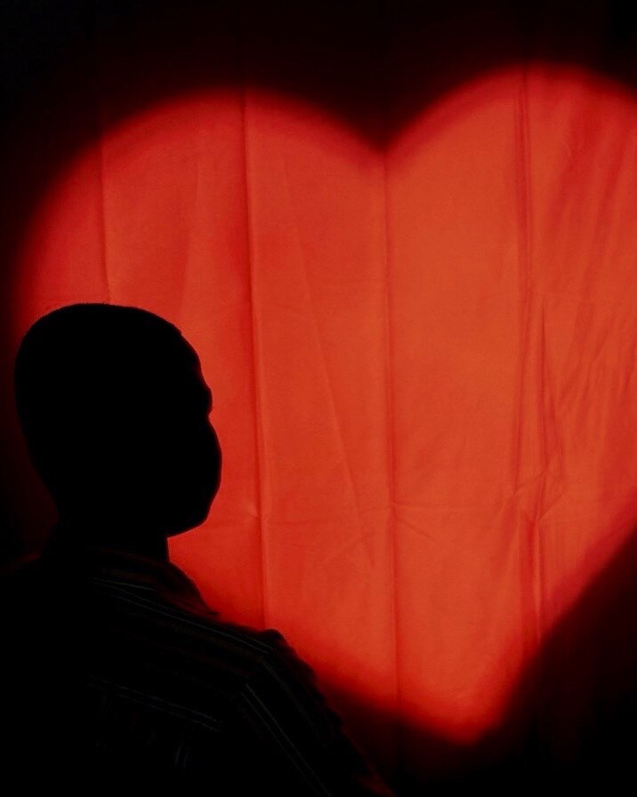 Silhouette portrait with red heart-shaped light